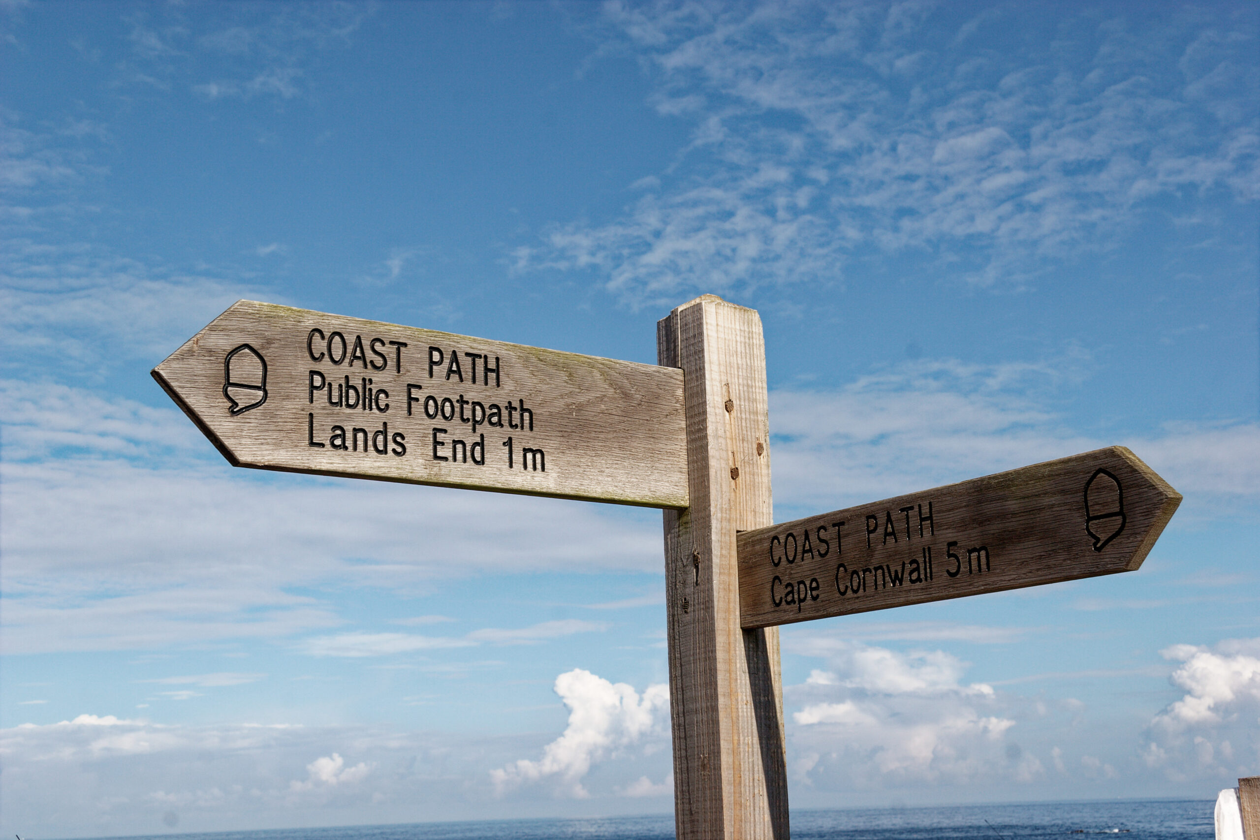 Lands End on a national signpost on South West Coast Path