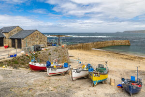 Fishing boats lined up at Sennen Cove Cornwall on the South West Coast Path