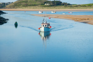 Fishing boat sailing into Padstow on the South West Coast Path
