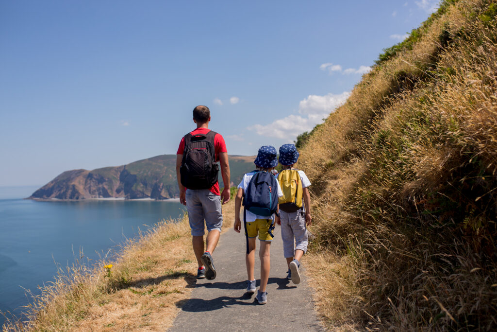 The family walking along the coast path in Devon on the South West Coast Path